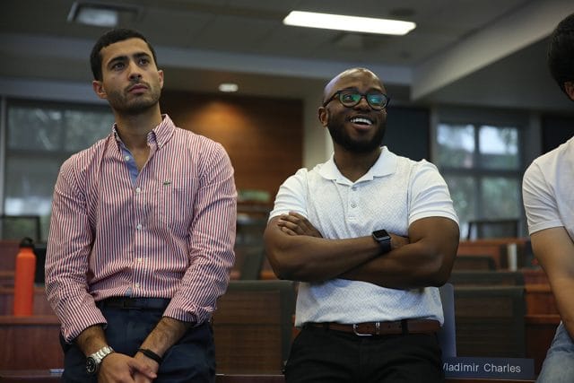 Two students standing in classroom group