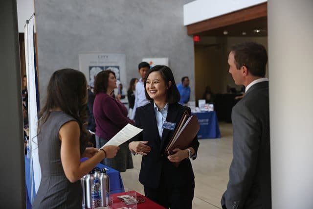 a group of 3 people at the Just in Time career fair