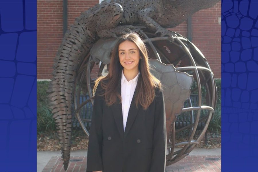 Andrea Handal stands in front of the Gator Ubiquity Statue