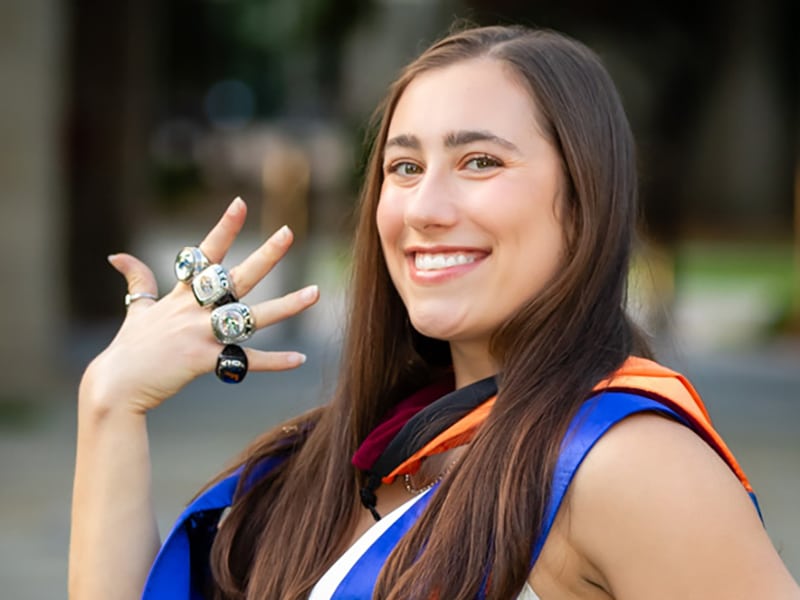 UF Warrington MS in Entrepreneurship Alum Leah Clapper (BS ’21, MA ’22, MSE ’23) displays her class rings during graduation