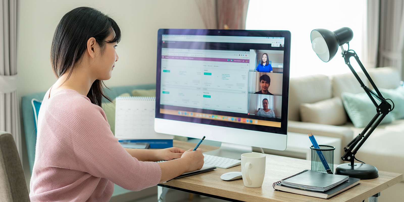Participating in the GatorNest consulting project, a UF Warrington Master of International Business student takes notes during a group video call