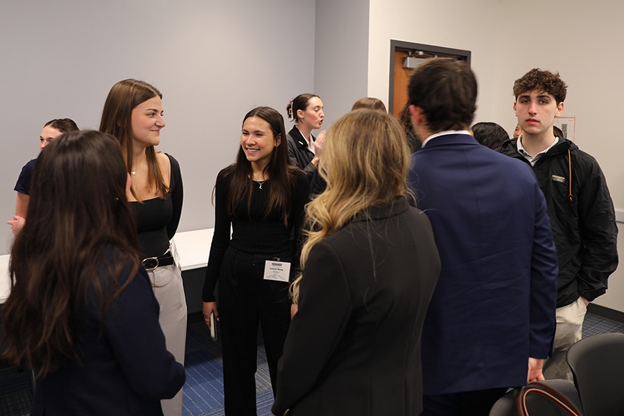 University of Florida students enrolled in the Warrington College of Business' Retailing Minor hold a meeting while wearing name tags