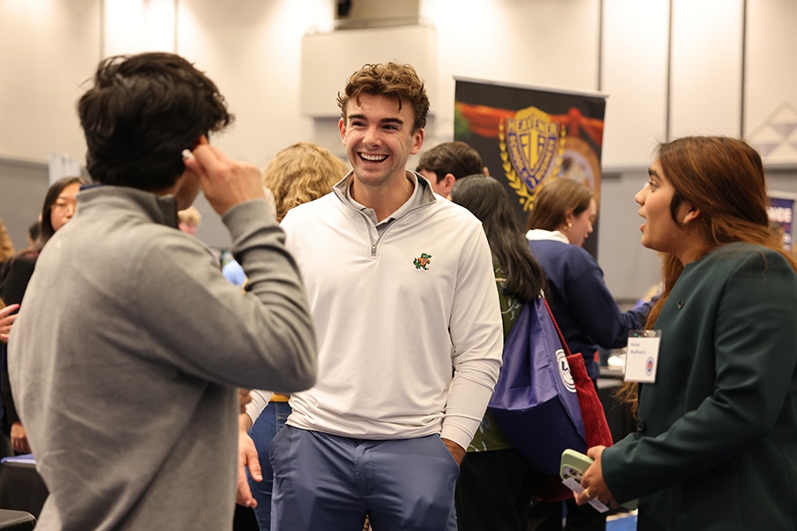 University of Florida students enrolled in the Warrington College of Business' Wealth Management Minor laugh or smile during a group conversation