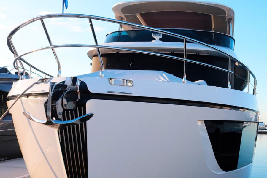A docked boat in a marina with a blue sky