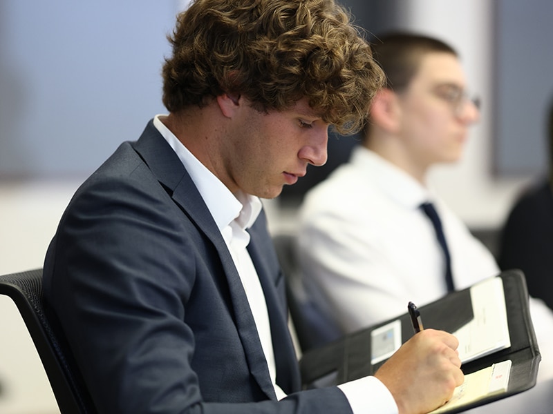 Focused student filling out an application. 