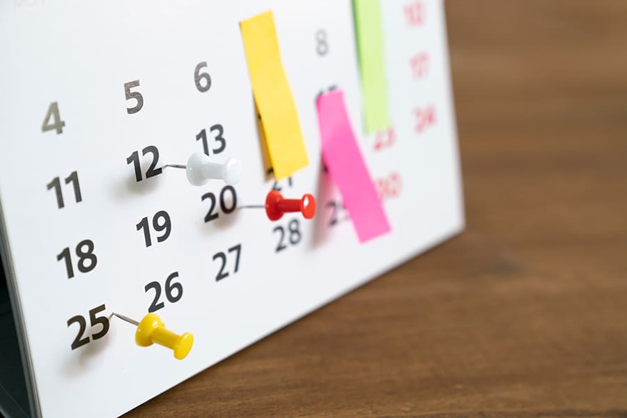 Close up of a calendar on a table.