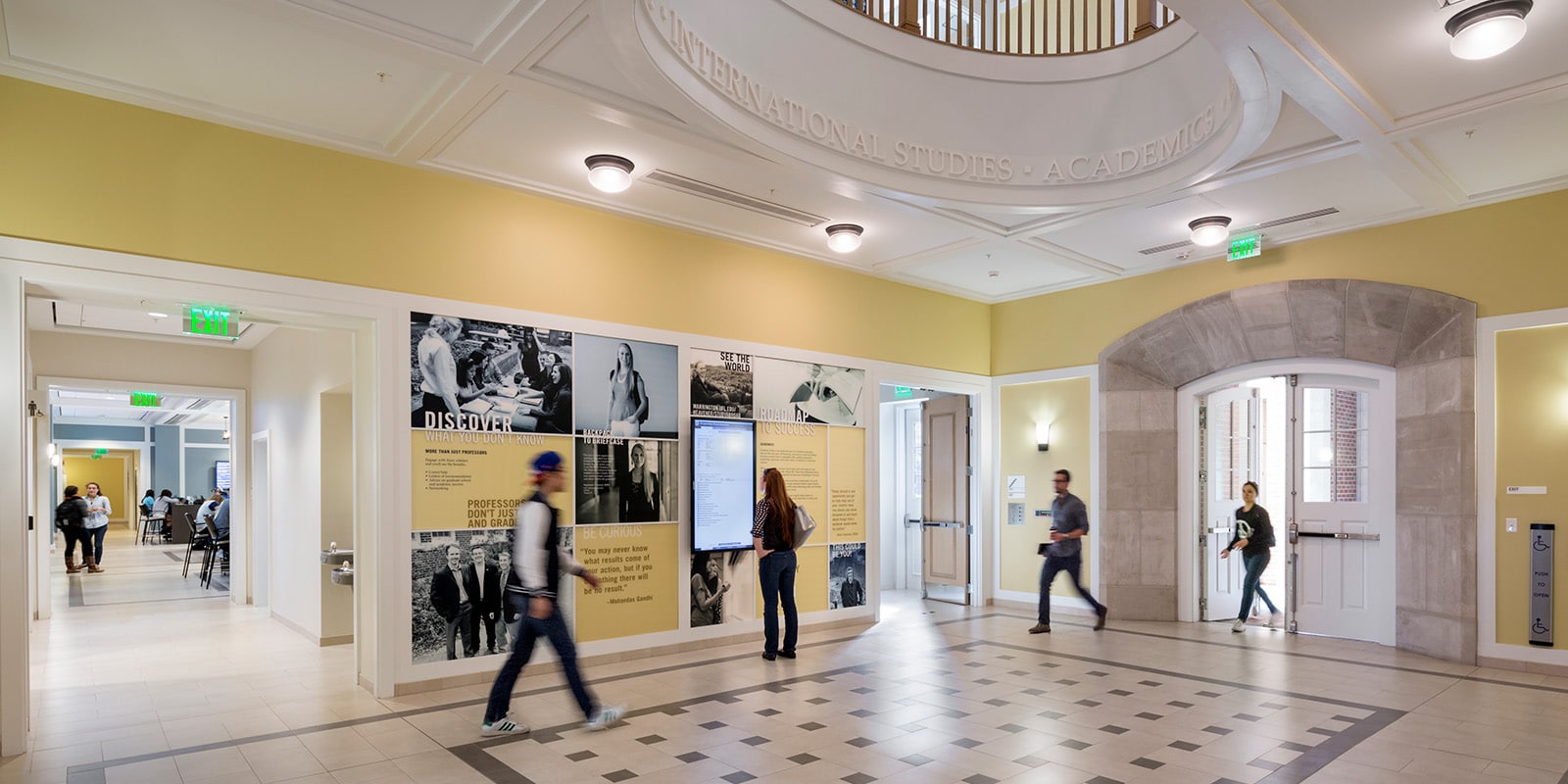Students and staff walking through Heavener Hall.