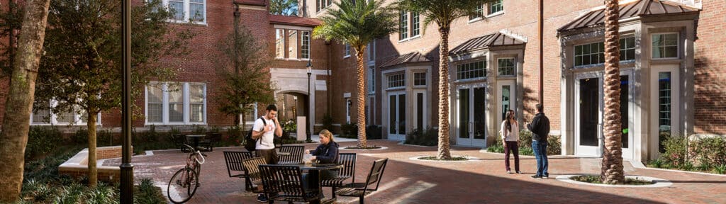 Heavener Hall courtyard with people mingling.