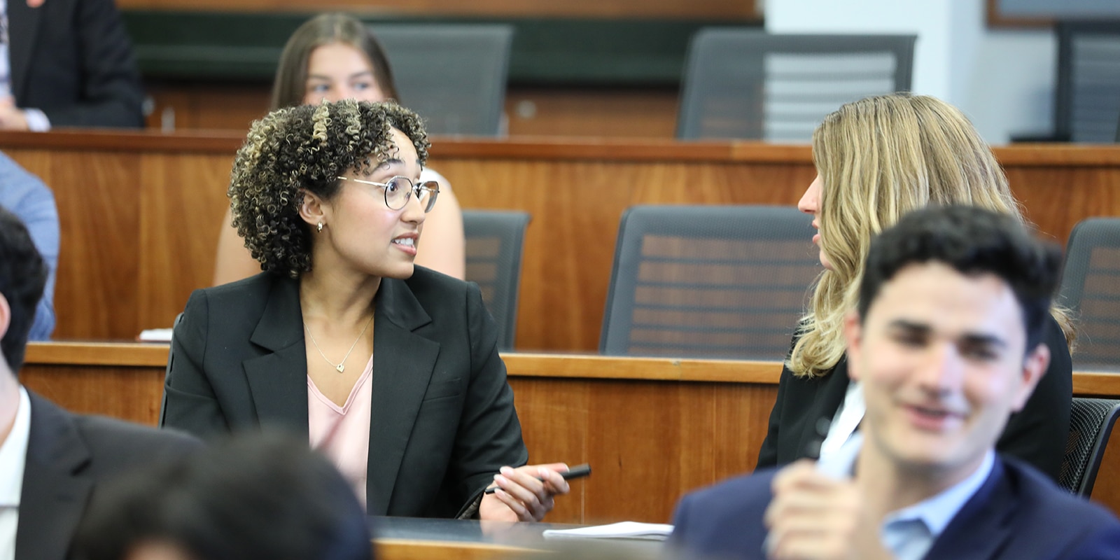 MS in Real Estate students converse in the audiences while waiting for a presentation by UF Warrington's Bergstrom Real Estate Center to begin