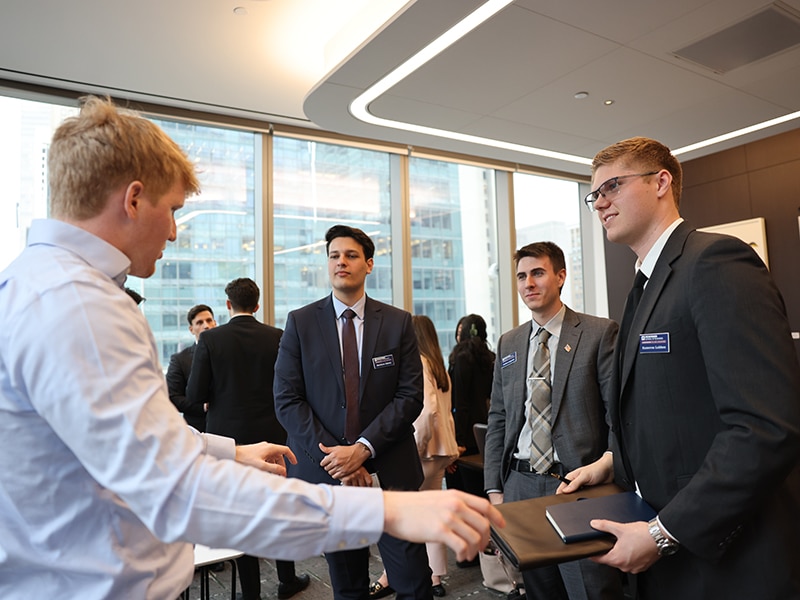 Group of professionally dressed students networking.