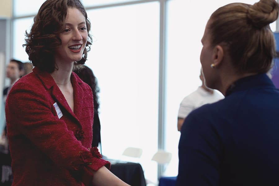 Two businesswomen shaking hands.