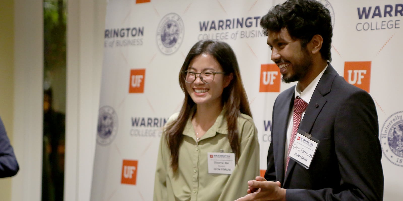 Two smiling PhD students.