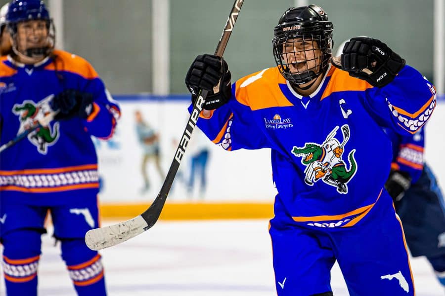 sarah pagels playing hockey on the rink in her uniform