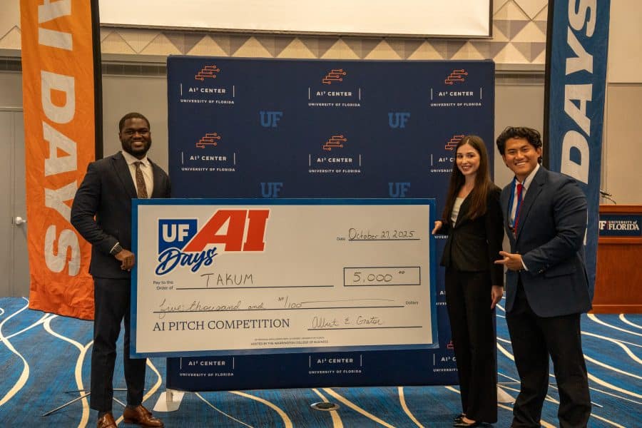 Imsulen “Allen” Jamir, Réka Holicsek and Samuel Frempong pose with their large $5,000 check.