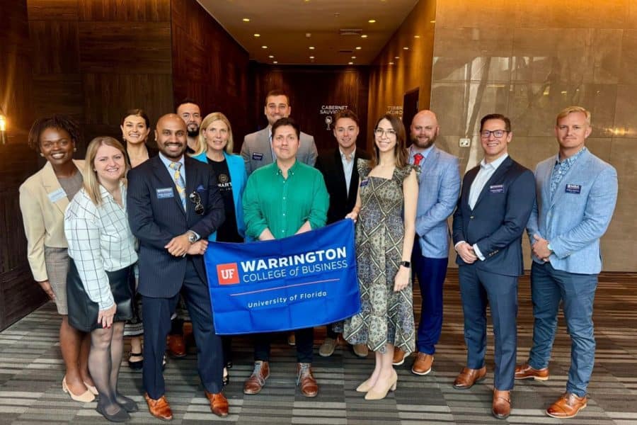 MBA team in Chile standing and smiling holding a Warrington banner